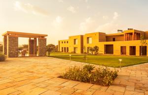 a house with a stone driveway in front of it at Dera Masuda Luxury Resort in Pushkar