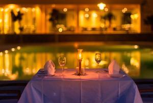 a table with wine glasses and napkins on it at Dera Masuda Luxury Resort in Pushkar