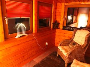 a living room with a chair and a window at Haus Talblick in Barbis