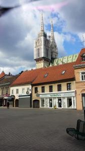 a building with a clock tower on top of it at Apartments Lina - Center with free parking! in Zagreb