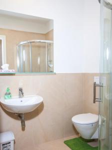 a bathroom with a sink and a toilet at Beautiful Central Apartment Thámova in Prague