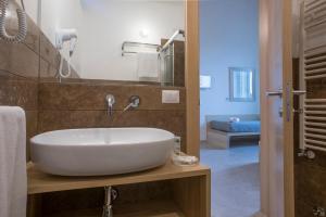 a bathroom with a white sink and a mirror at La Filanda Salento in Casamassella +46 photos