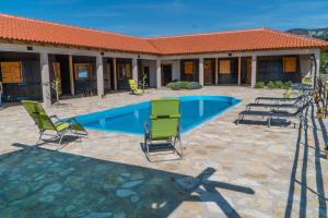 - une piscine avec des chaises et une maison dans l'établissement Agroturizam Duvančić - Konoba dida Marka, à Drniš
