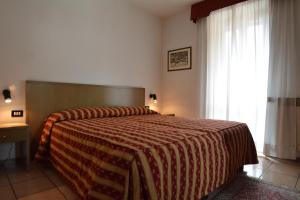 Voodi või voodid majutusasutuse Hotel Pineta toas