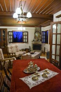 a living room with a table with dishes on it at Anna's Villa Portaria in Portaria