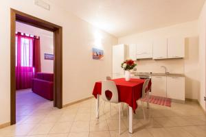 a kitchen with a table with a vase of flowers on it at Residence Barbara in Trapani
