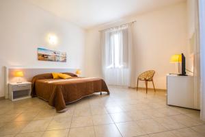 ein Schlafzimmer mit einem Bett und einem TV in der Unterkunft Residence Barbara in Trapani