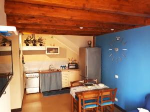 a kitchen with a table and a refrigerator at FraMavi in Cefalù