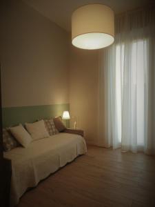 A bed or beds in a room at Appartamenti Emilio