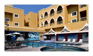 a building with a swimming pool in front of it at Gulf Gate Hotel in Manama
