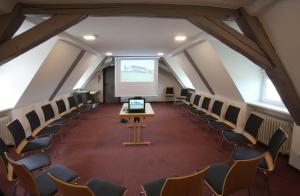 Zimmer im Dachgeschoss mit Stühlen und einem Projektor in der Unterkunft Jugendhaus Michaelsberg in Cleebronn