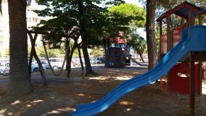 a playground with a blue slide in a park at Savonaamare in Savona