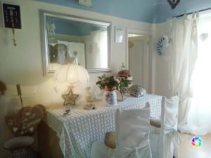 a dining room with a table and a mirror at Lunartista in Varazze +15 photos