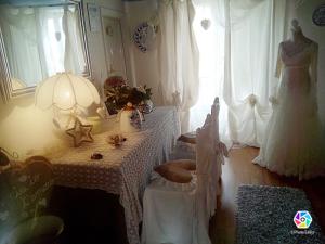 a room with a table with a wedding dress on a window at Lunartista in Varazze