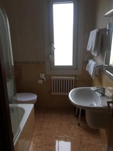 a bathroom with a sink toilet and a window at Hostal Pancorbo in Pancorbo +21 photos