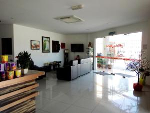 a lobby of a store with a couch and a table at Aloha Hotel in Lumut