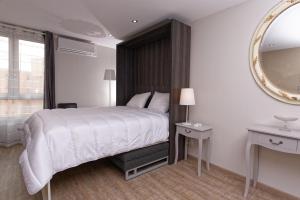 a bedroom with a large bed and a mirror at At home in lyon in Lyon