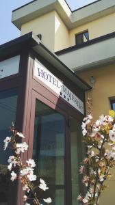 a hotel maker sign on the front of a building at Hotel Majestic in San Giuliano Milanese