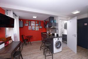 
a kitchen with a refrigerator, stove, microwave and a table at At home in lyon in Lyon
