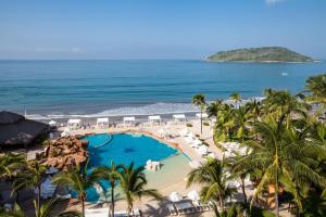 an aerial view of a resort with a pool and the ocean at Costa de Oro Beach Hotel in Mazatlán