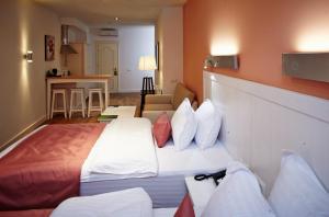 Postel nebo postele na pokoji v ubytování Rudolfo Hotel