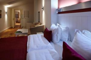 Postel nebo postele na pokoji v ubytování Rudolfo Hotel