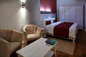 Postel nebo postele na pokoji v ubytování Rudolfo Hotel