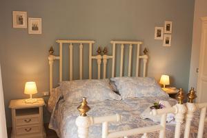 a bedroom with a white bed and two lamps at Il Punto a Maglie in Maglie