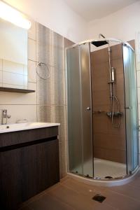 a bathroom with a shower and a sink at Kappatos Studios & Apartments in Lassi