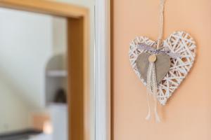 a heart shaped ornament hanging on a wall at Bauernhof Marquardt in Fehmarn