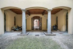 a building with columns and a door with bikes in it at Soleluna Apartments - by Relais Di Giada in Como