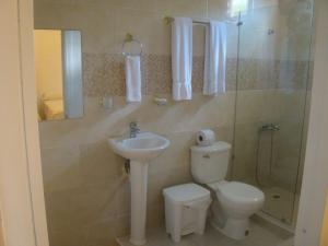 a bathroom with a toilet and a sink at Hotel Galsi in San Felipe de Puerto Plata +31 photos