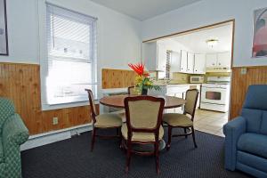 a kitchen and dining room with a table and chairs at Shore Beach Houses - 119 F Franklin Avenue in Seaside Heights