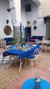 a blue table and chairs in a patio at Riad Jean Claude in Fez