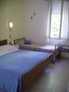 Postel nebo postele na pokoji v ubytování Albergo Maria Gabriella