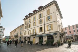 a large building with people walking in front of it at Sole&Luna Comolake Apartments in Como