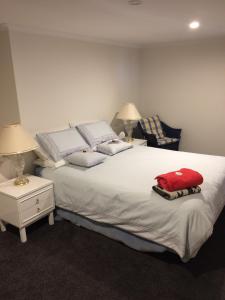 a bedroom with a large bed with a red pillow on it at Panorama on Sorell B&B in Sorell