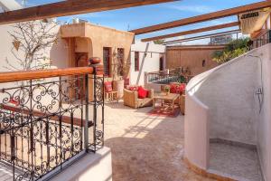 patio al aire libre con escalera y balcón en Riad Carina, en Marrakech