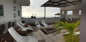 a living room with white furniture and a view of the ocean at Casa del Parque Vallarta in Puerto Vallarta