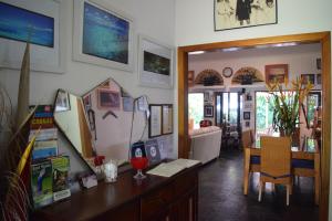 a living room with a table and a dining room at South Pacific Bed & Breakfast in Clifton Beach