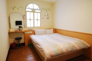 Postel nebo postele na pokoji v ubytování Sun Ho Inn