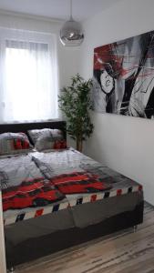 um quarto com uma cama com um quadro na parede em King23 em Siófok