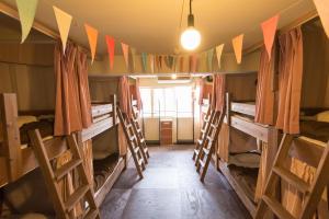 a room with a bunch of bunk beds at Hostel Q in Osaka