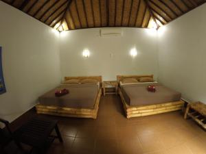 Cama o camas de una habitación en Alexyane Paradise Bungalow