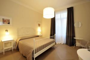 a bedroom with a white bed and a window at A Due Passi B&B in Castellammare di Stabia