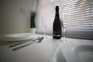 - une bouteille de vin assise sur une table avec des verres dans l'établissement Apartment on SVYATOHO TEODORA SQUARE 5, à Lviv
