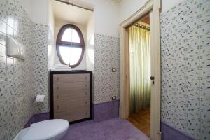 a bathroom with a toilet and a window at B&B 'O Sole Mio! in Naples +37 photos