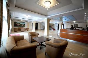 a lobby with chairs and a table in a building at Hotel Dallas in Negreşti-Oaş
