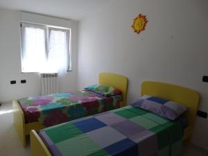 Postel nebo postele na pokoji v ubytování Appartamento La Collinetta