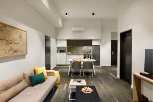 a living room with a couch and a table at Quest Fremantle in Fremantle